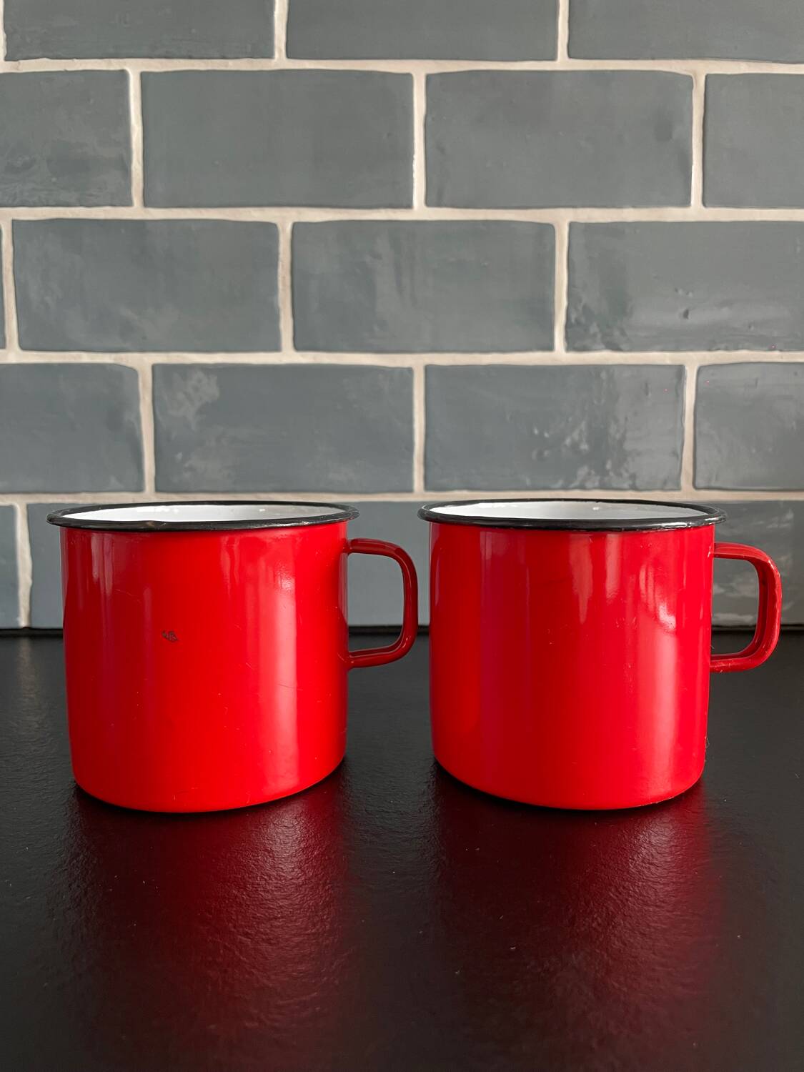 Red enameled sheet metal mug