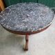 Round pedestal table with marble top and mahogany tripod from the 19th century