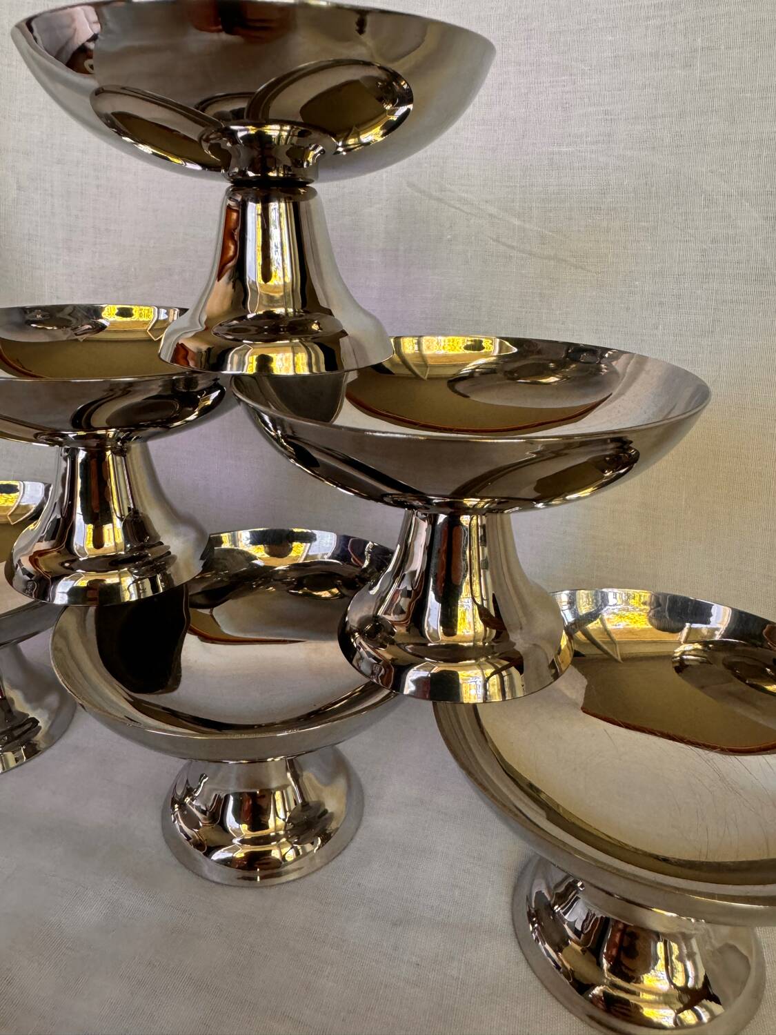 Set of 6 stainless steel ice cream bowls by Guy Degrenne with matching spoons.