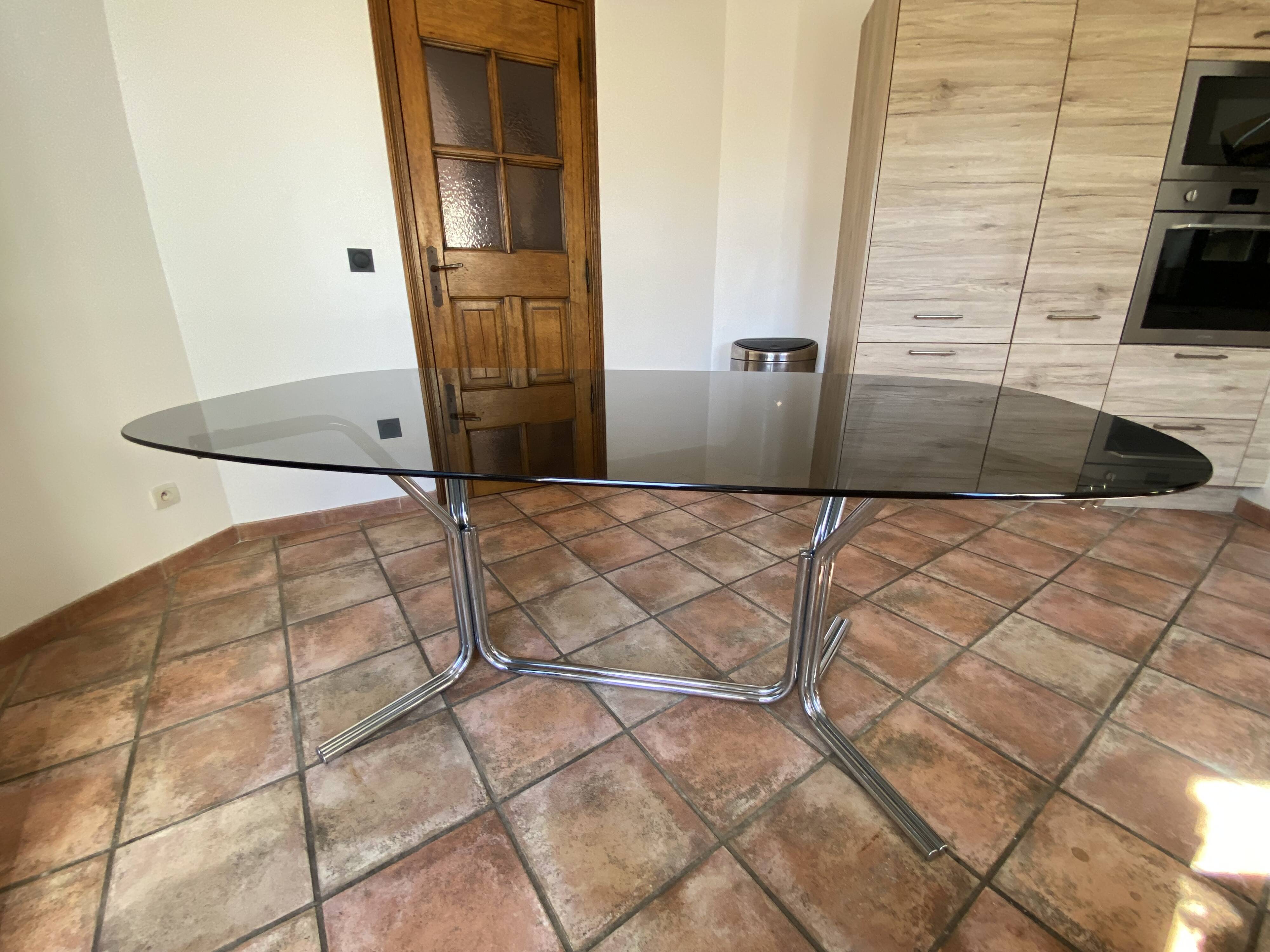Oval table. 1970. Steel and smoked glass. 180x100