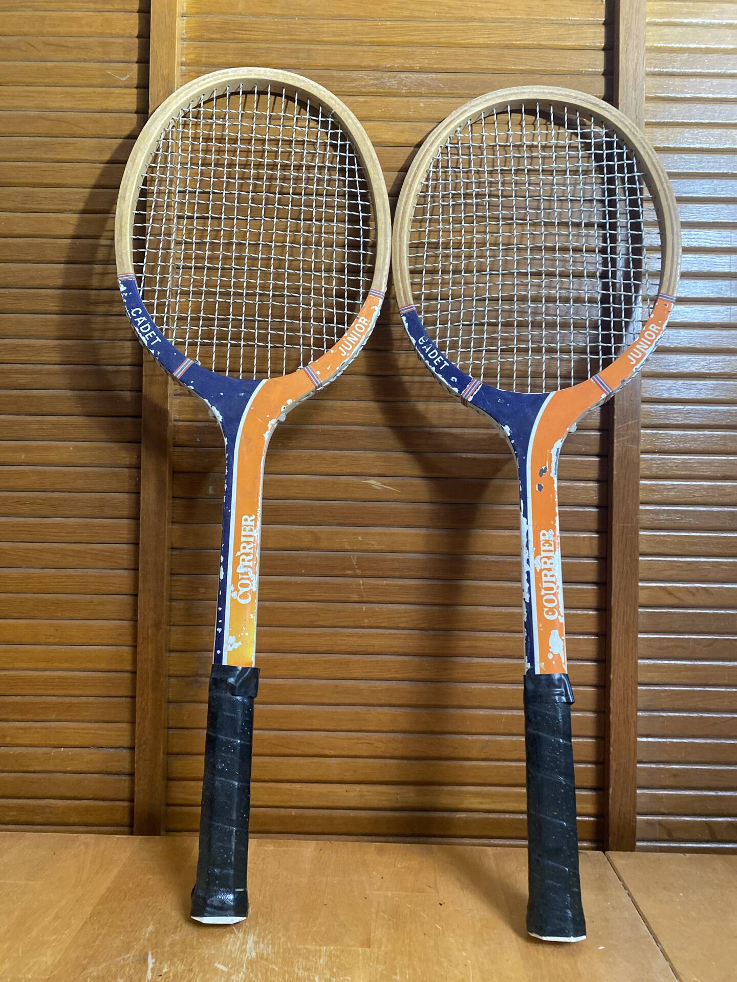 Pair of vintage wooden tennis rackets for cadet junior sport courier