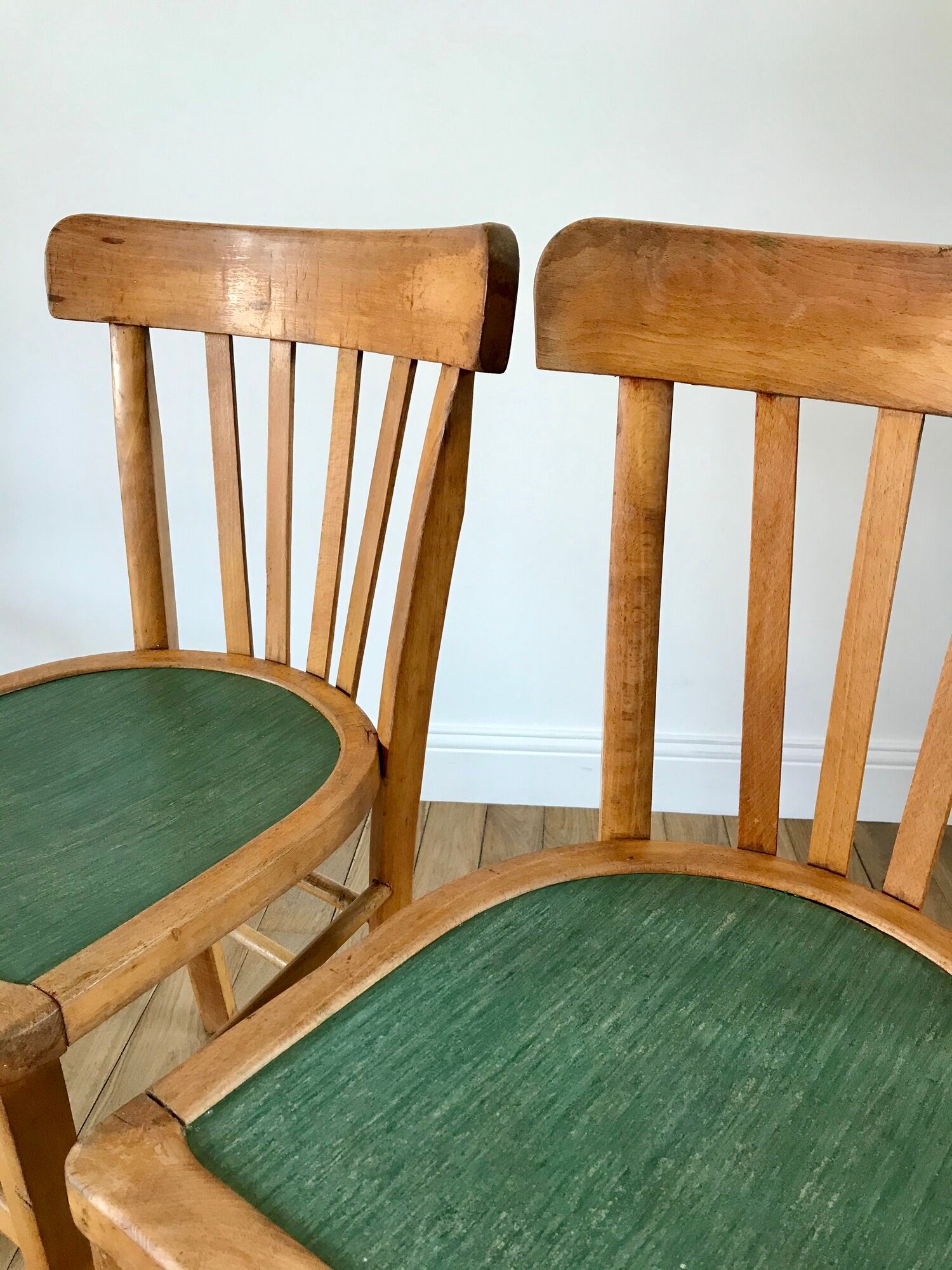 Pair of bistro chairs in light curved wood and green seat 1950s