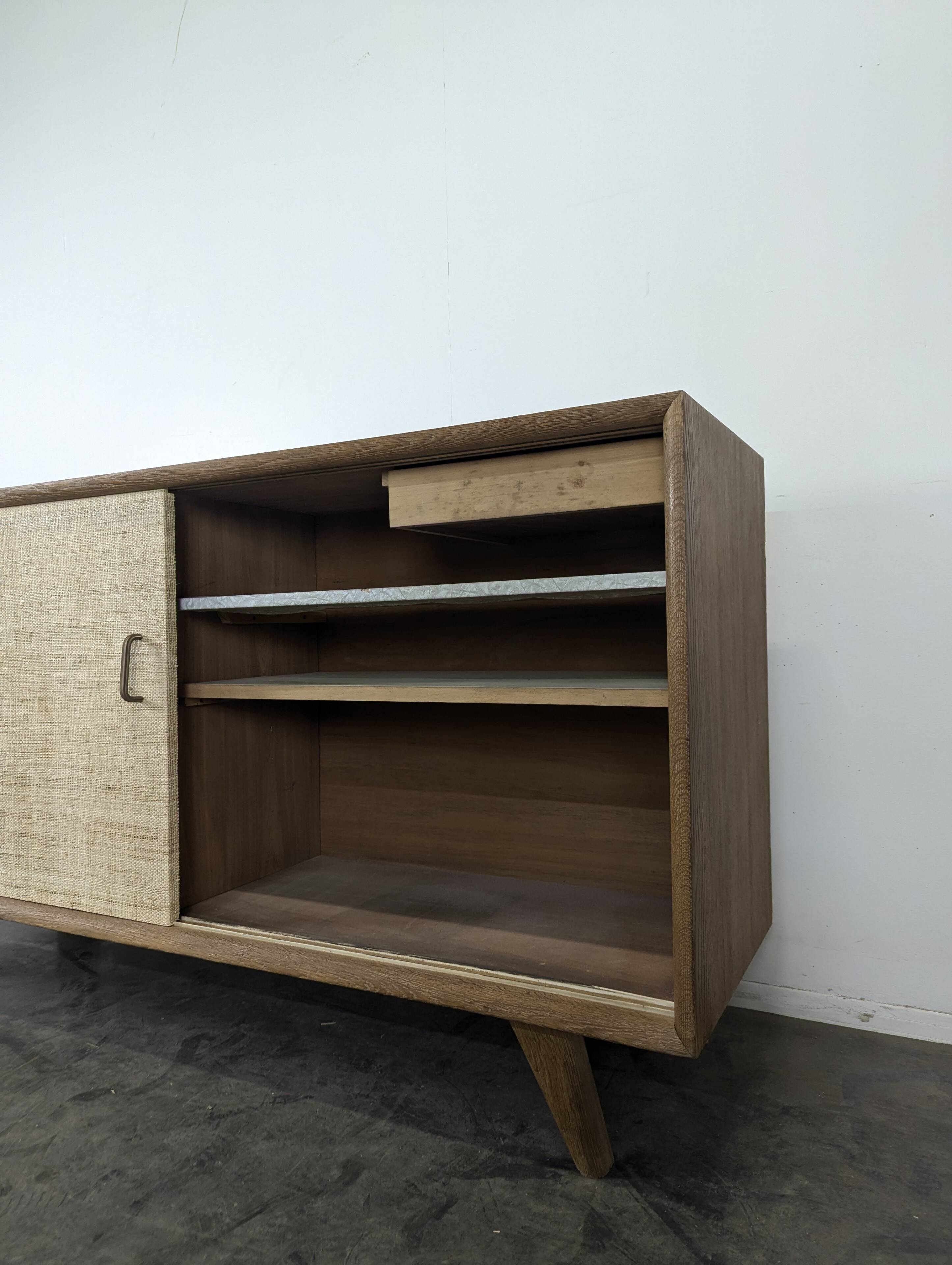 Modernist sideboard in oak with rattan doors.
