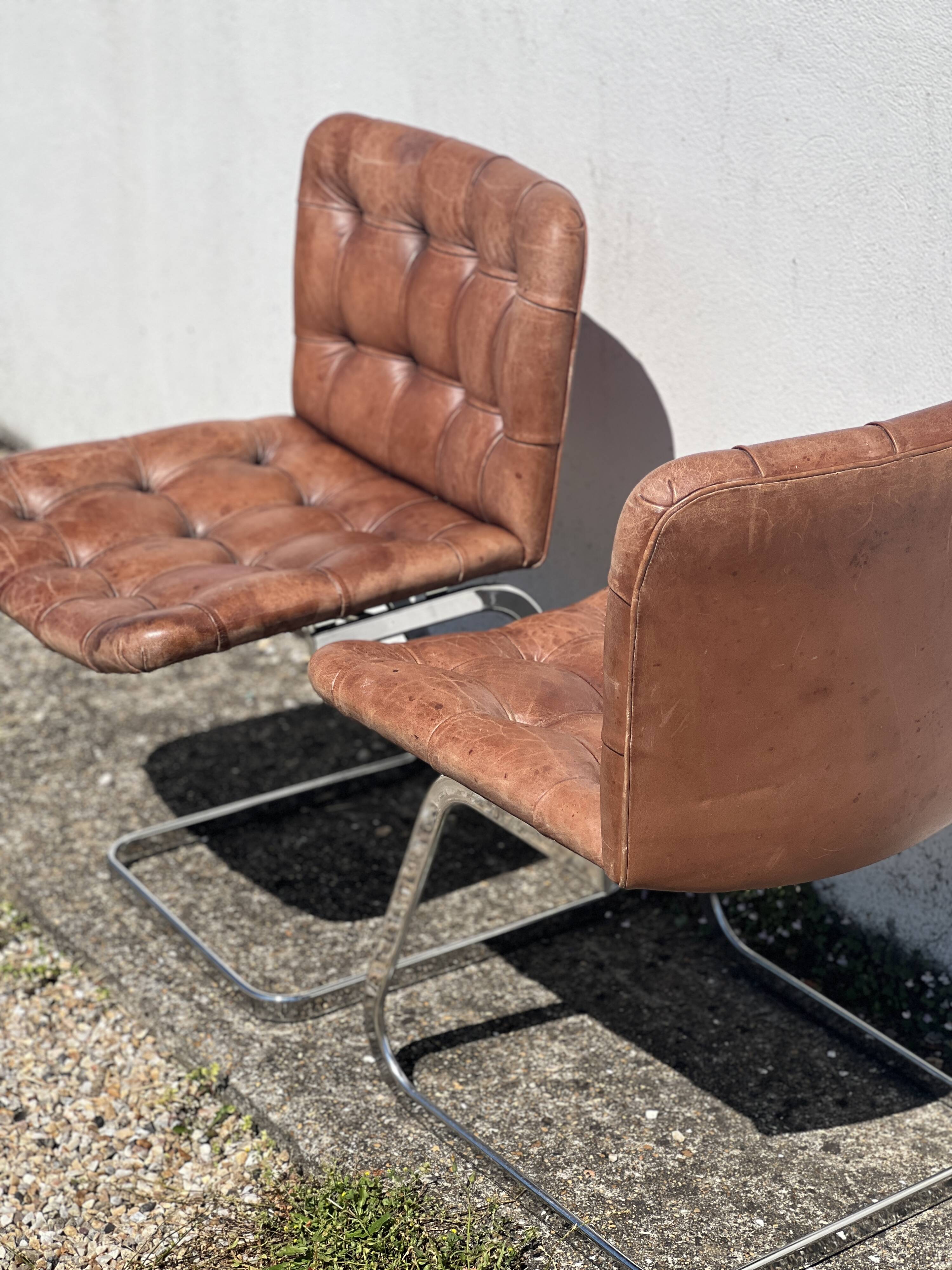 Pair of leather chairs by Robert Haussman