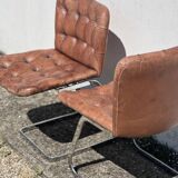 Pair of leather chairs by Robert Haussman