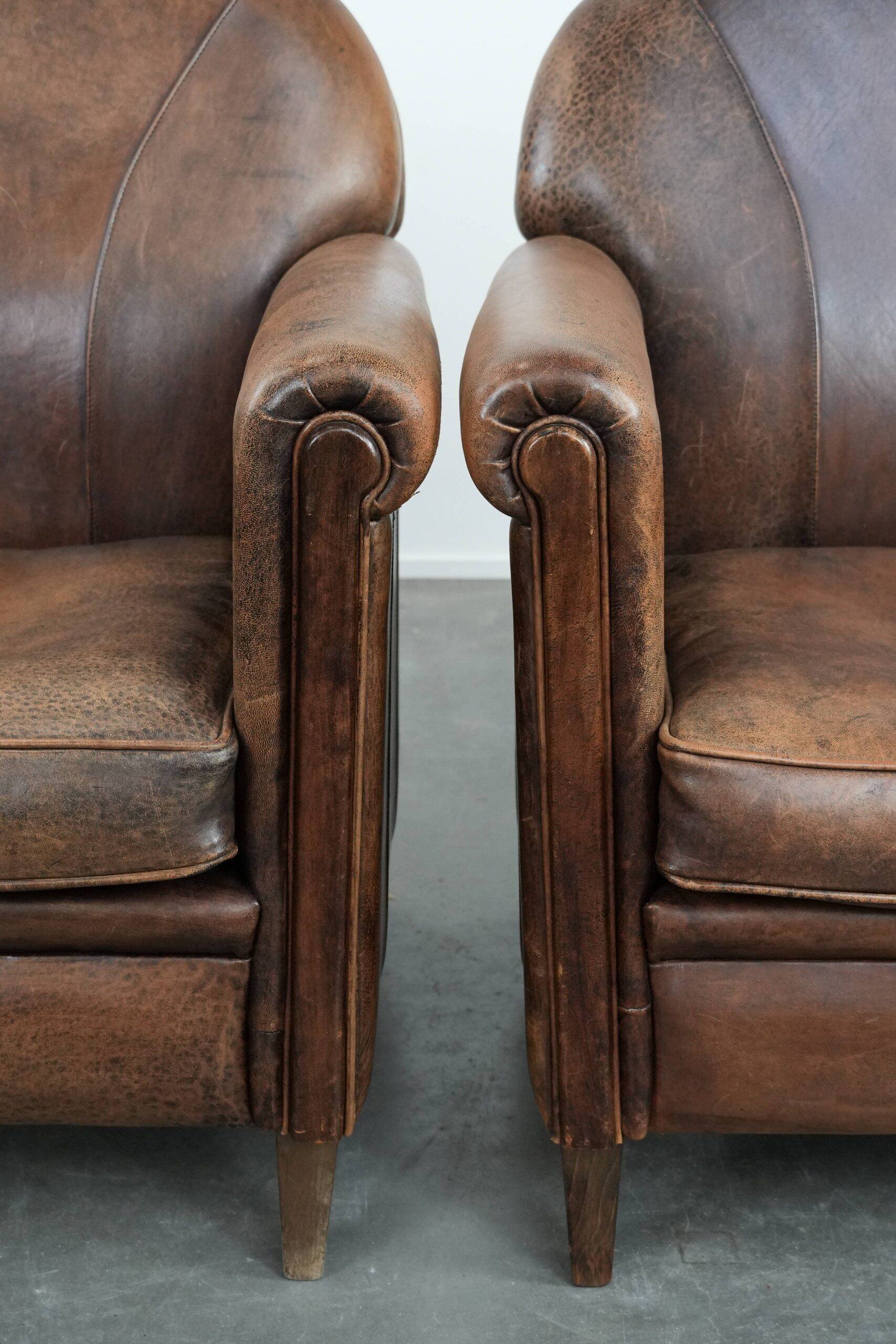 Set of 2 vintage sheepskin armchairs with a characterful appearance