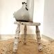 Patinated tripod stool