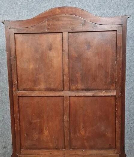 Curved library with two walnut doors, in Louis XV style.