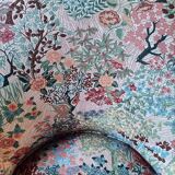 pair of toad armchairs in floral fabric.