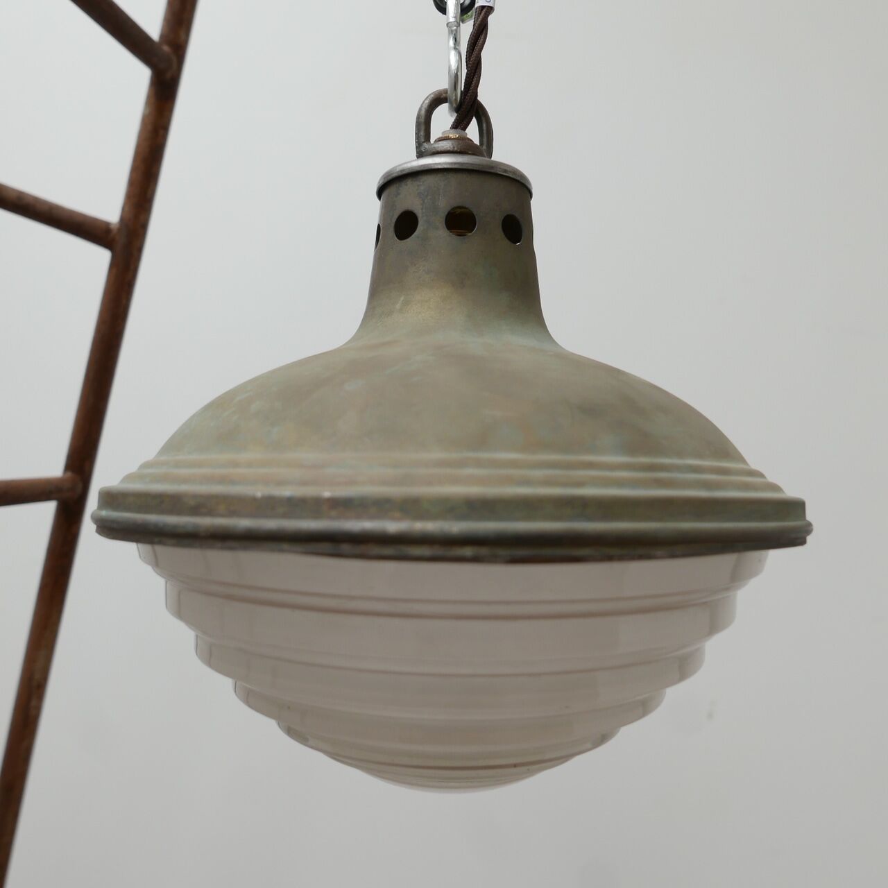 Patinated metal and glass Holophane pendant light