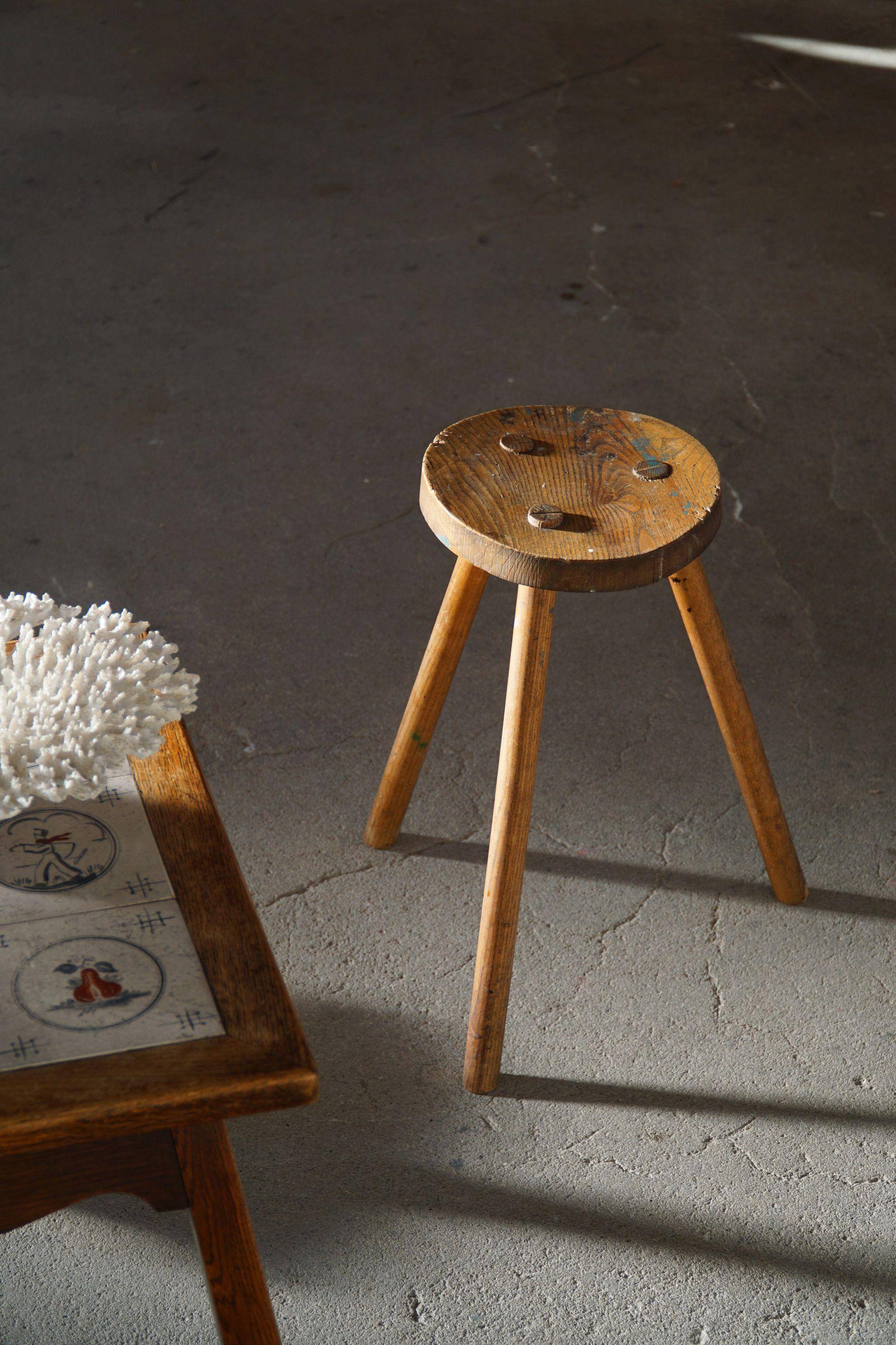 Tripod stool made of solid oak, by a Danish cabinetmaker, mid-century, around 1960.