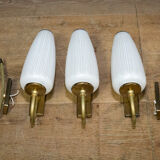 Ornate wall lamp made of milk glass and brass