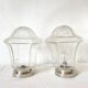 Pair of lantern-style ceiling lights or antique lamps.