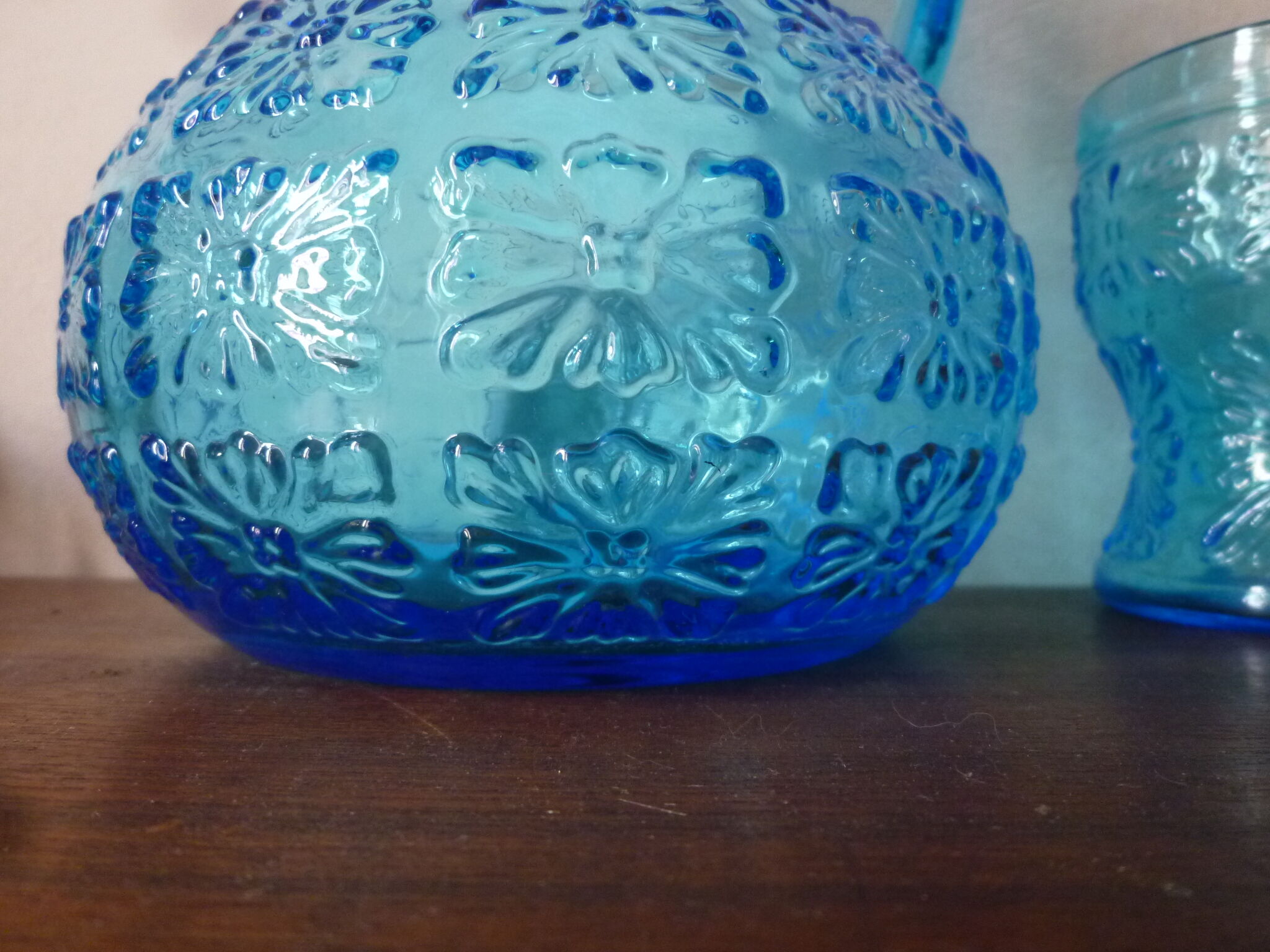 Blue glass carafe and two glasses