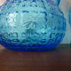 Blue glass carafe and two glasses