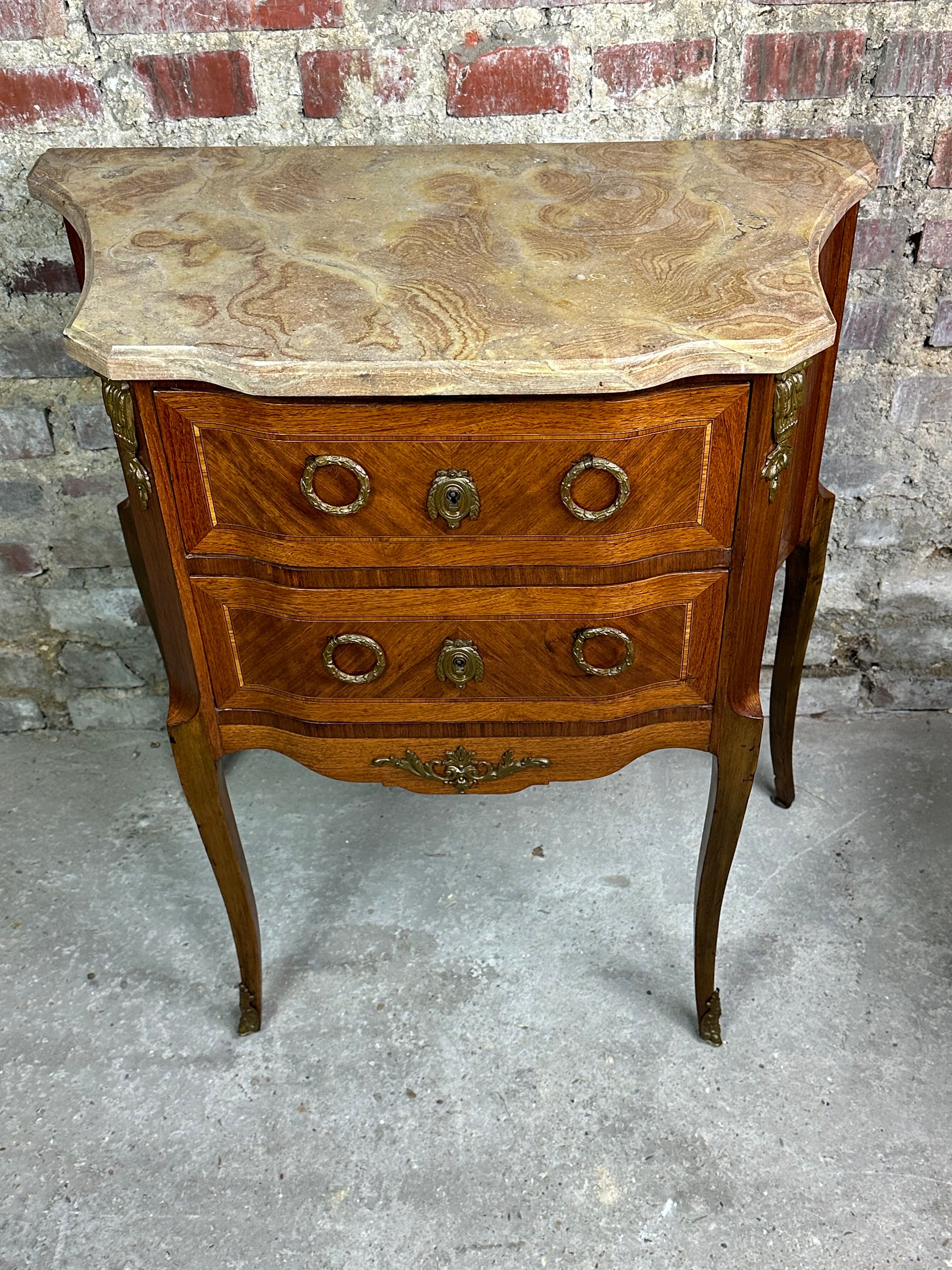 Louis XV/XVI transition style curved chest of drawers in marquetry and bronze