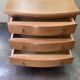 Blonde wooden doll's chest with brass handles.