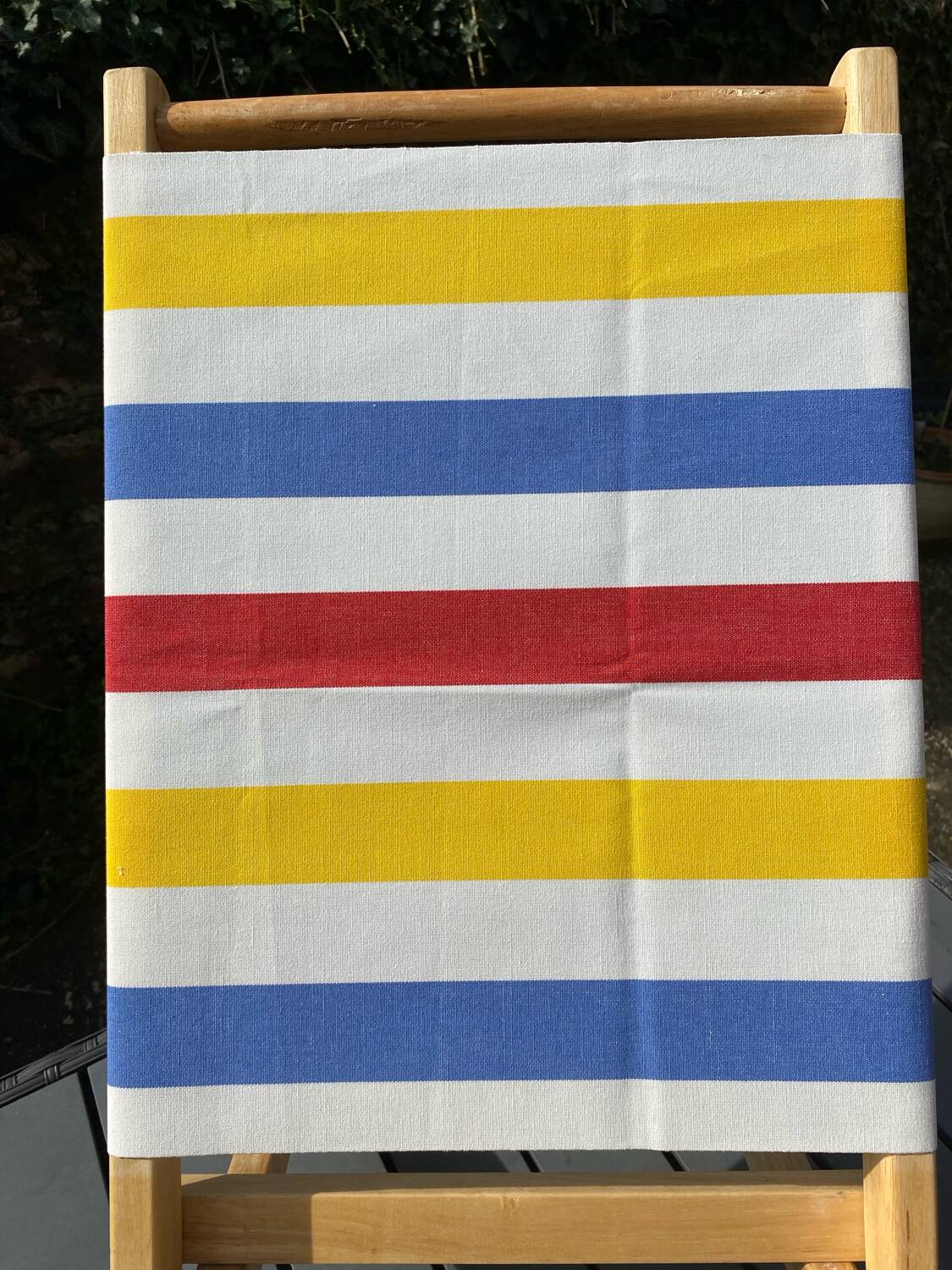 Folding chair in wood and striped fabric
