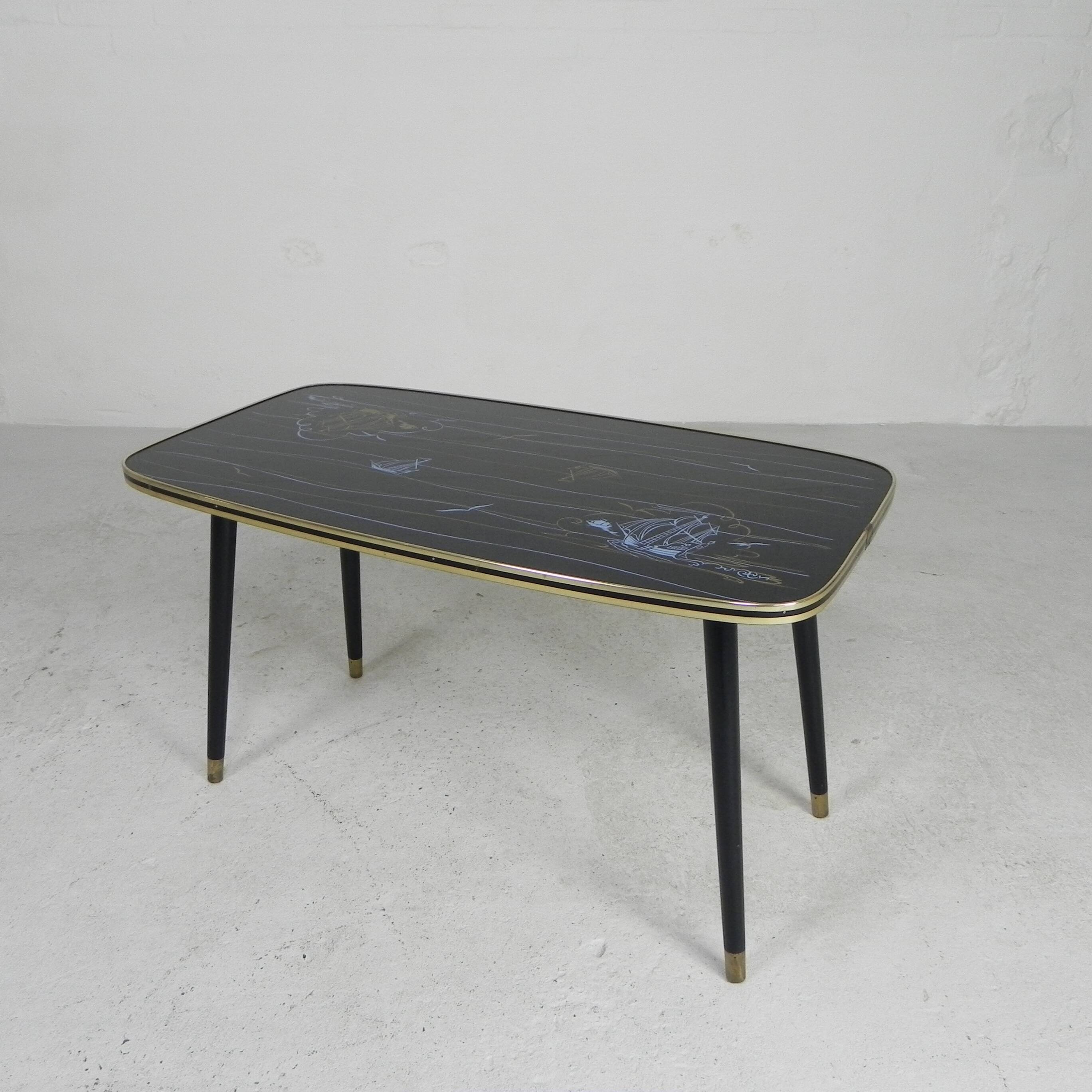 Vintage coffee table with glass top and angled legs