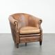 Club chair made of sheepskin leather finished with decorative nails