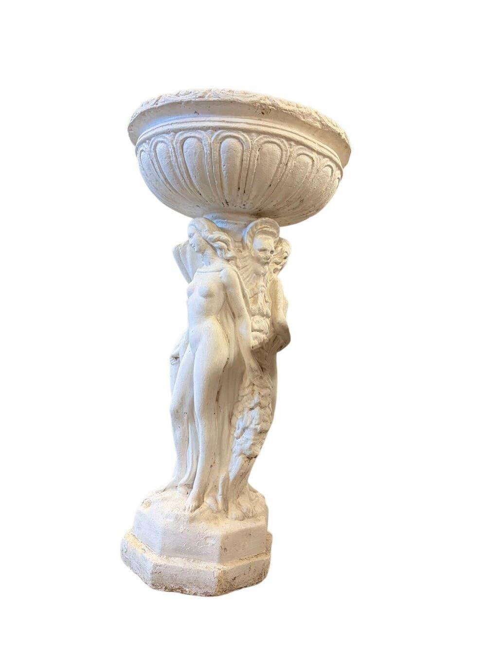 Vintage white concrete garden statue adorned with planter.