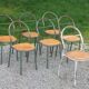 Set of 7 metal chairs by René Herbst with wooden seats.