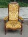 Louis XV Voltaire armchair in solid wood and yellow floral velvet fabric.