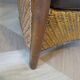 Colonial style armchair in woven rattan and exotic wood