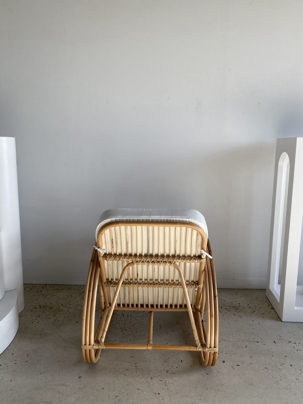 Large rattan rest chair and white cushions
