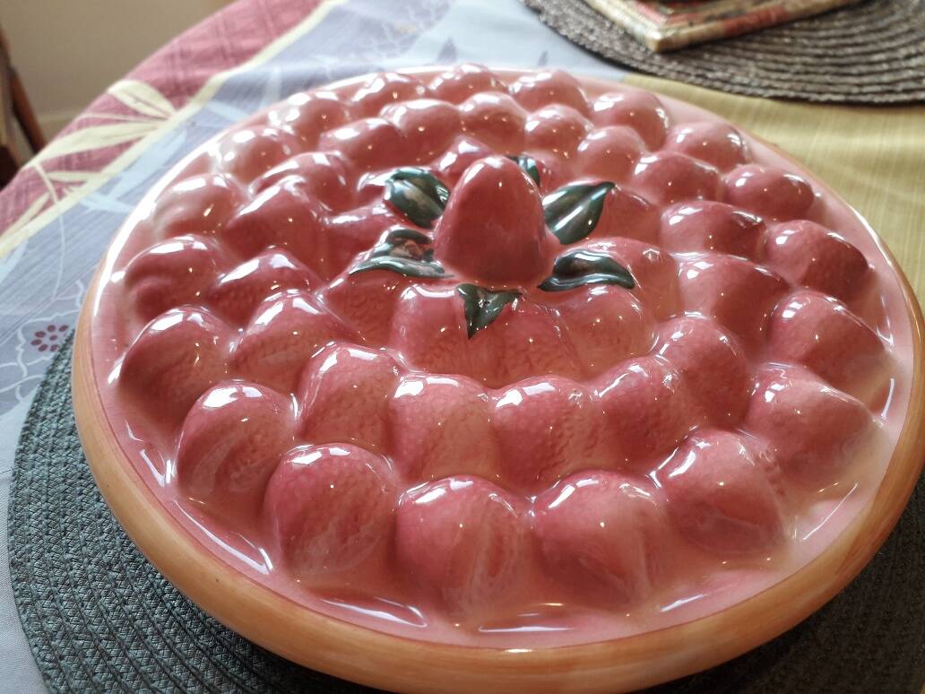 Glazed ceramic dessert plate with strawberry design.