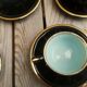 Set of 9 cups and sub-cups in black ceramic and colored gold border