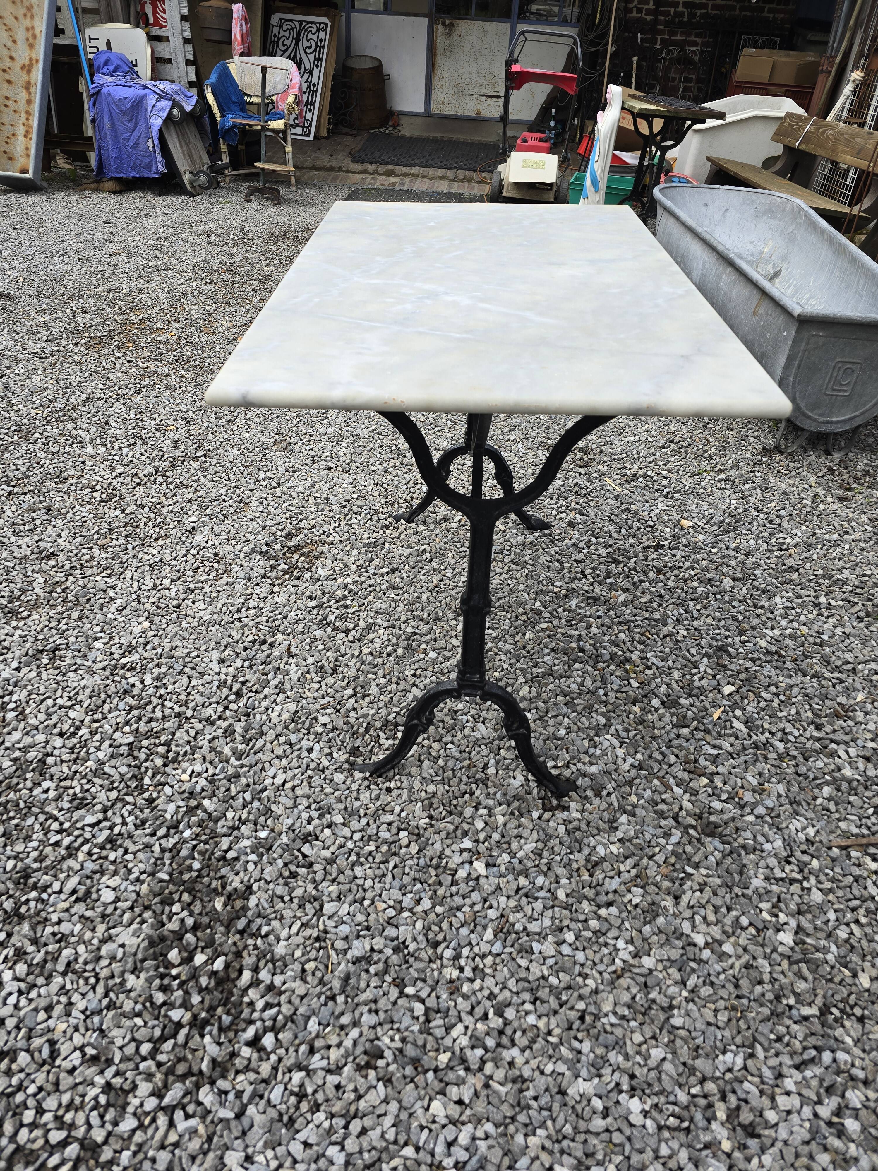 Bistro table with marble top and cast iron base