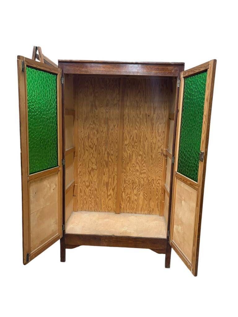Vintage wooden display cabinet with green glass.