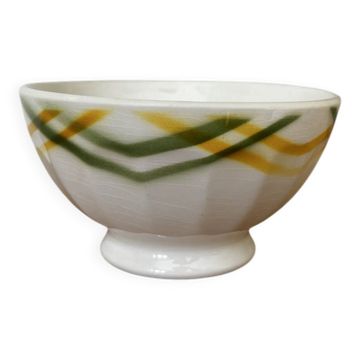 Old faceted bowl printed with yellow and green tea towel.