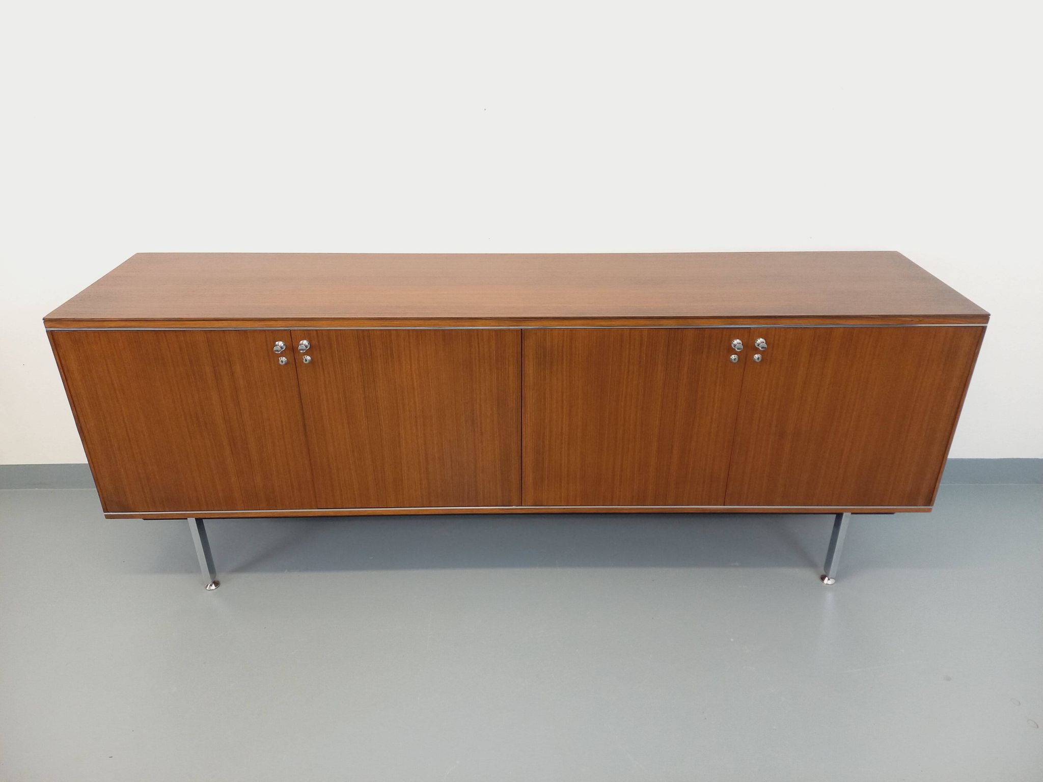 Vintage modernist enfilade in rosewood and chrome metal from the 60s and 70s.