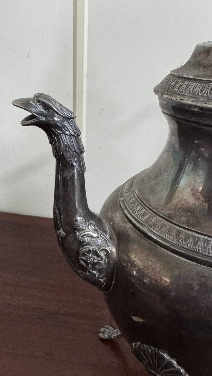 Empire style silver-plated verseuse, resting on three sculpted feet.