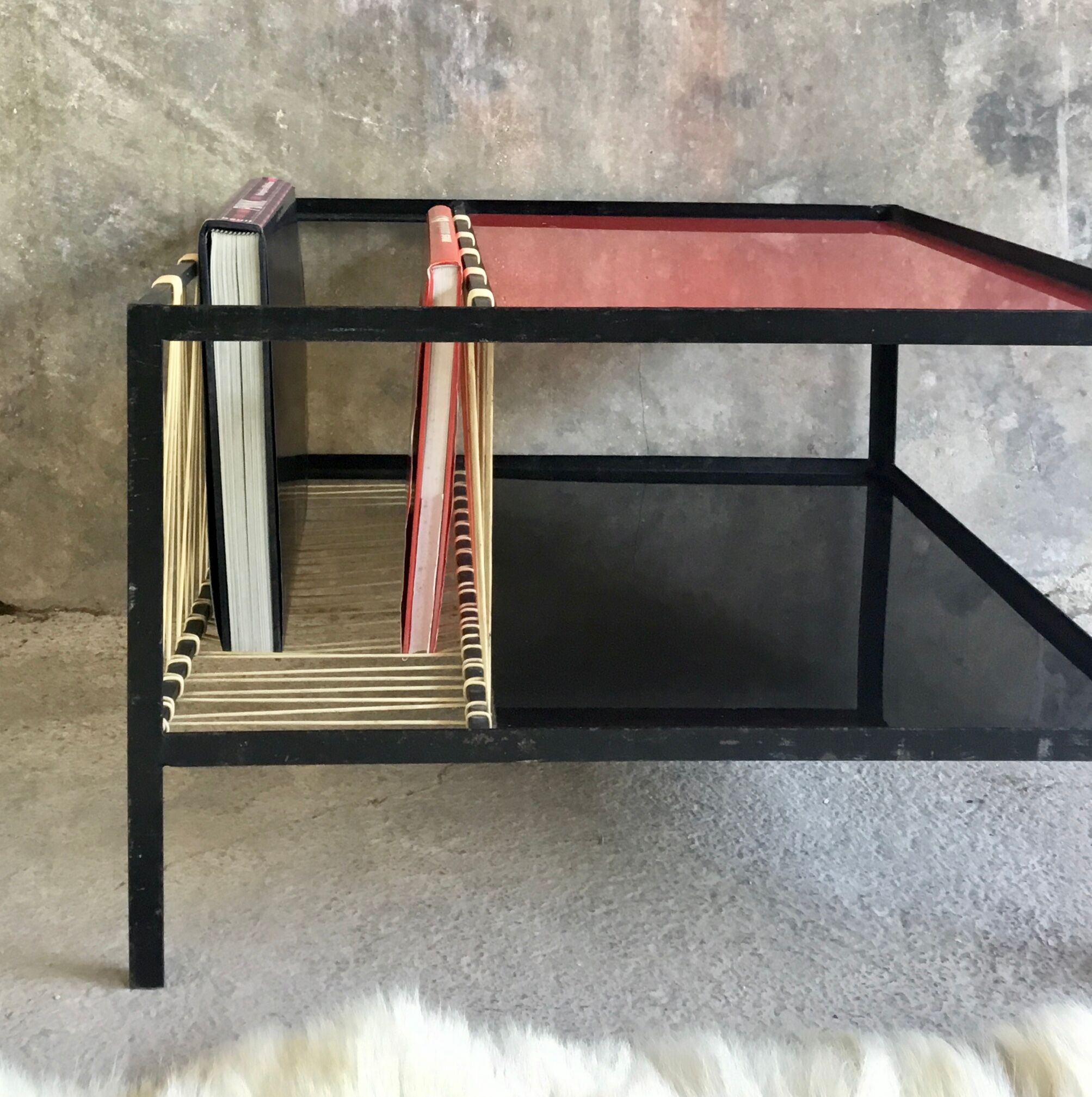 Modernist metal coffee table with a magazine rack in 1950s design.