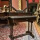 Antique English mahogany dressing table with carved details, black marble, and mirror.