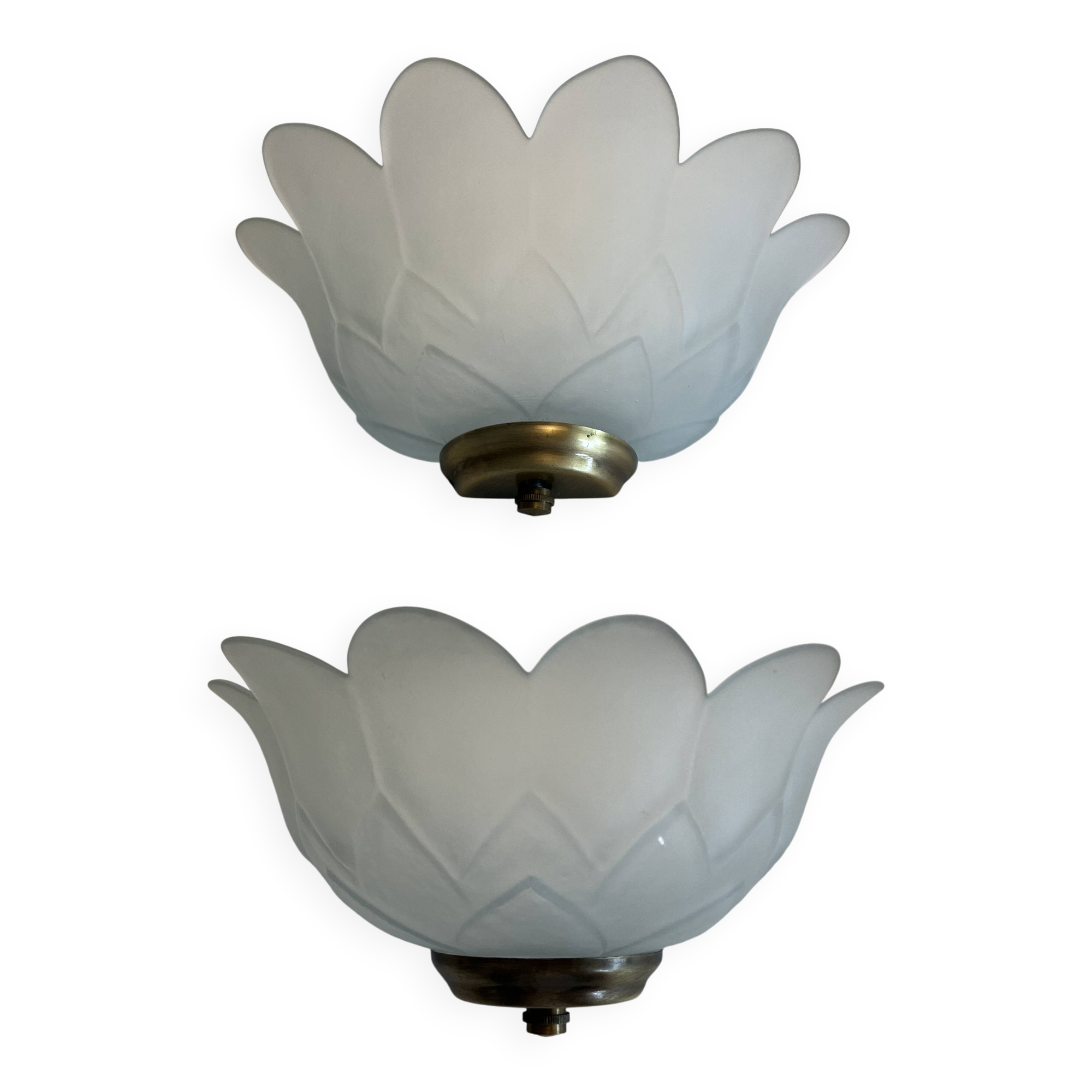 Pair of glass shell wall sconces with brass frames