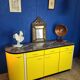 Vintage yellow sideboard, and black marble top.