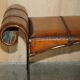 Vintage Spanish window bench in hand-stitched leather and restored iron.