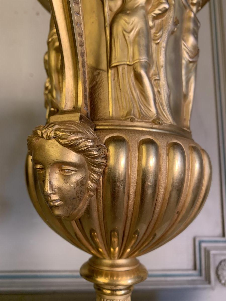 Golden bronze urn, base of red griotte marble.