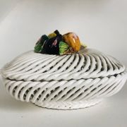 Covered basket in white woven ceramic and fruit slip.