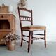 Antique chair turned wood sitting velvet flowers