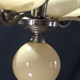 Chrome metal chandelier with 5 pale yellow opal shades from the 1950s.