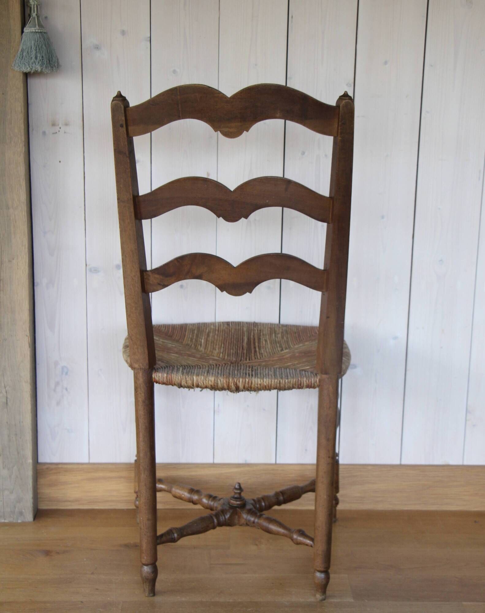 Antique chair with coloured rush seating.