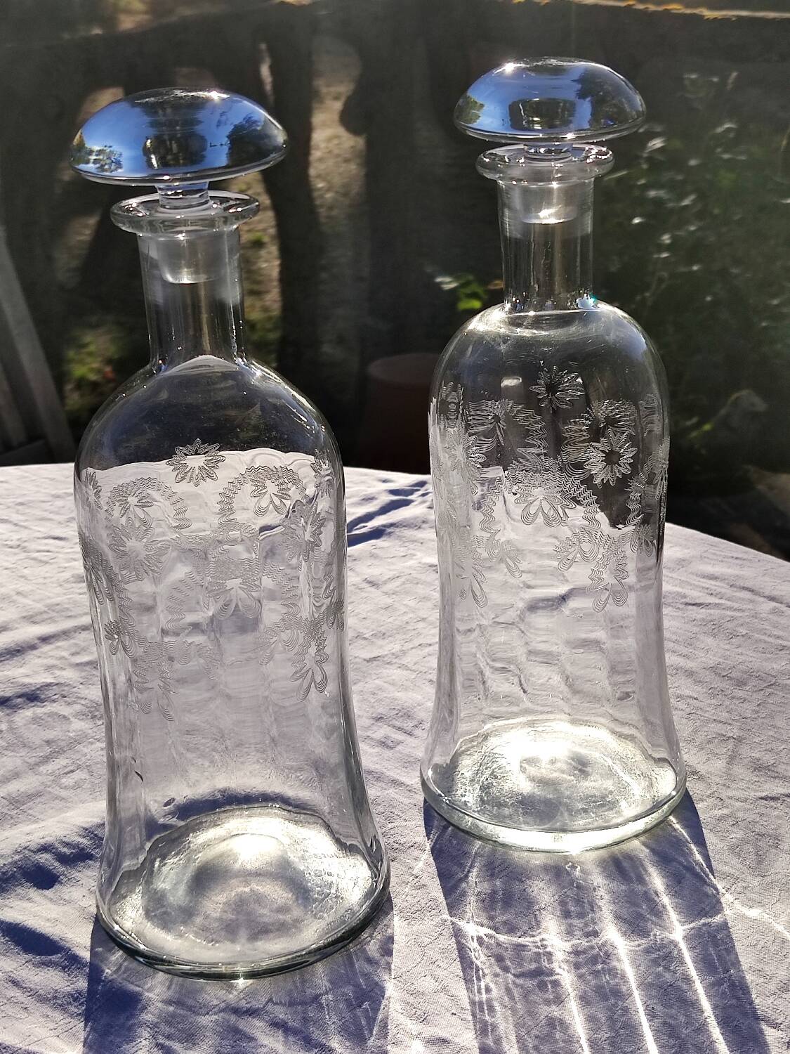 Two antique engraved glass bottles