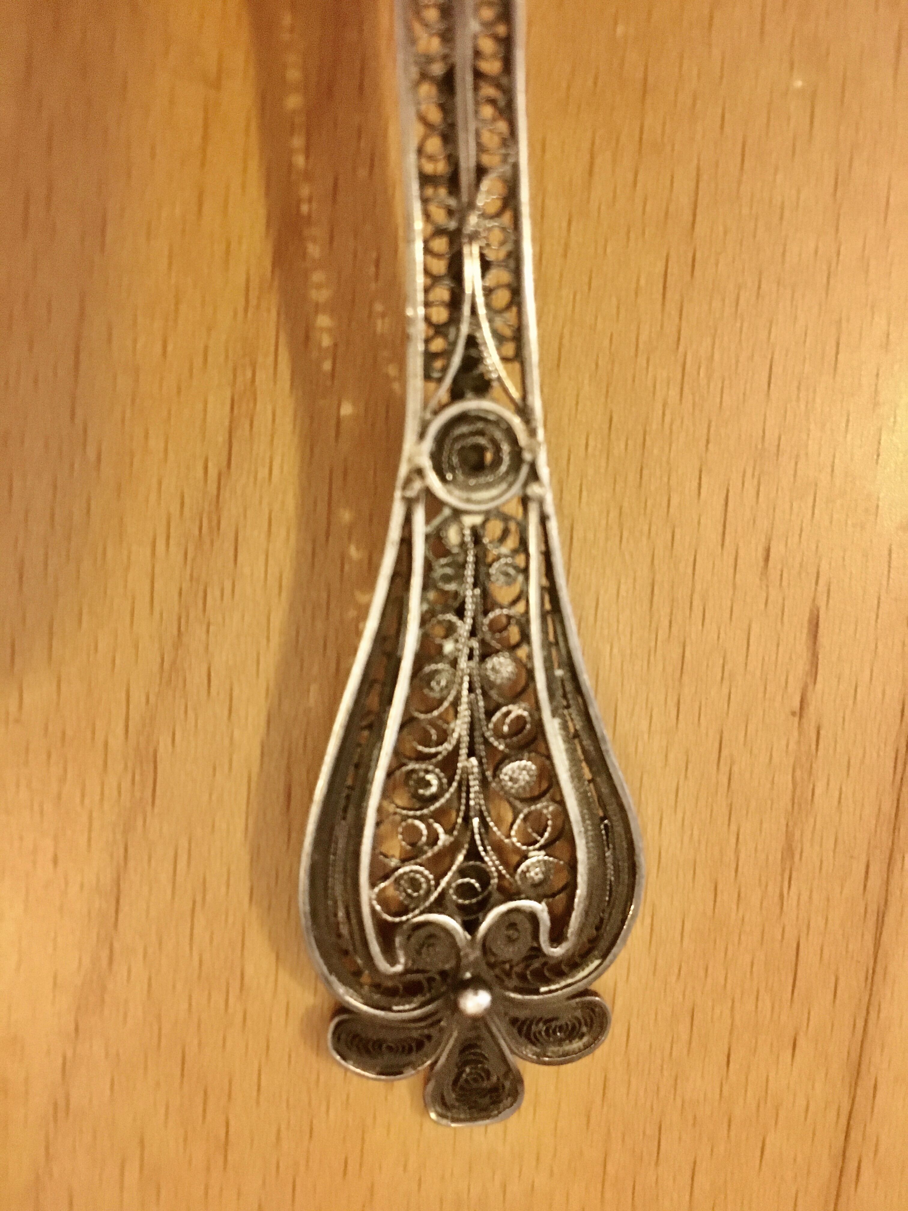 silver sprinkler spoon