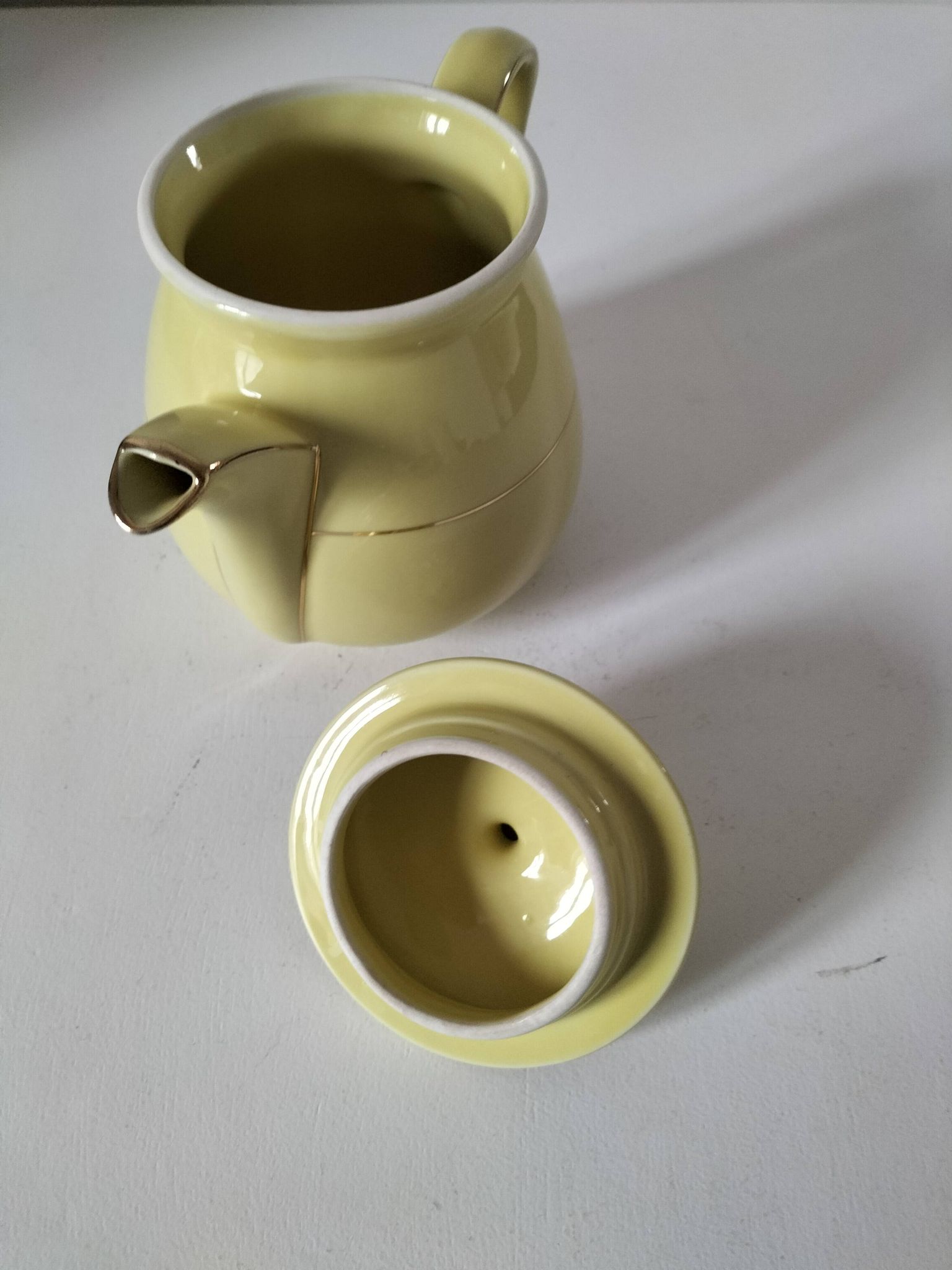 Vintage teapot in pastel yellow earthenware with gold trim