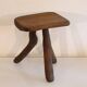 Patinated tripod stool in solid wood from the 1960s.